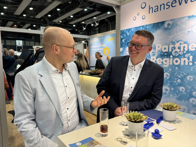 Zwei Männer sprechen am Messestand.